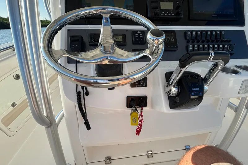 Slide: The Image of 2014 Robalo R300 Center Console helm with steering wheel and Yamaha controls. - 16