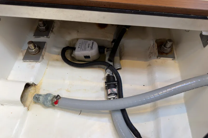 Slide: The Image of Bilge area of 2016 Jeanneau Sun Odyssey 439 with pump and hoses visible. - 77