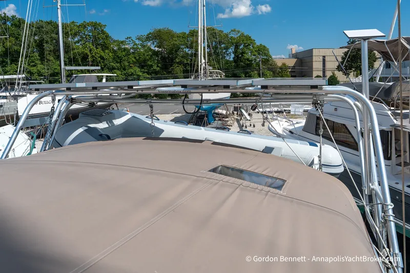 Slide: The Image of 2016 Jeanneau Sun Odyssey 439 sailboat with solar panels, docked in a marina. - 34