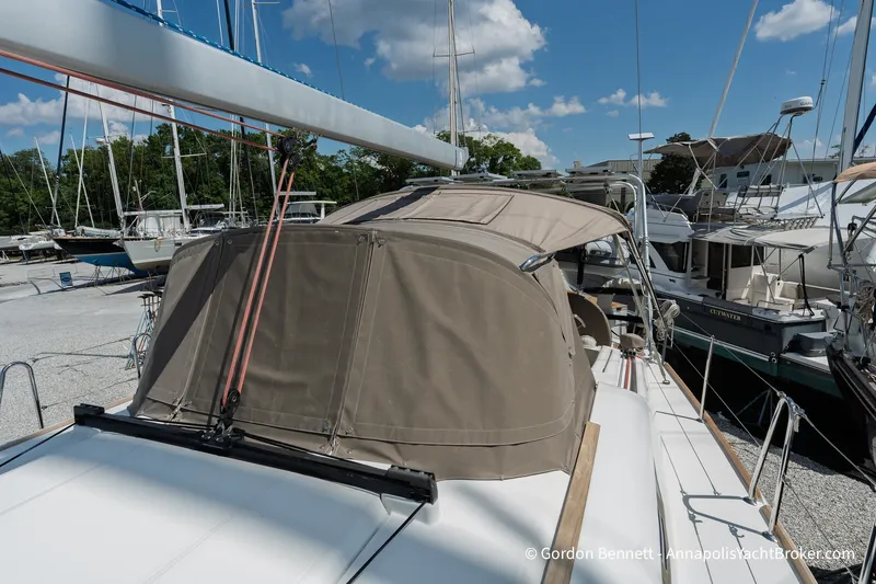 Slide: The Image of 2016 Jeanneau Sun Odyssey 439 sailboat docked, featuring a beige canopy under a clear blue sky. - 24