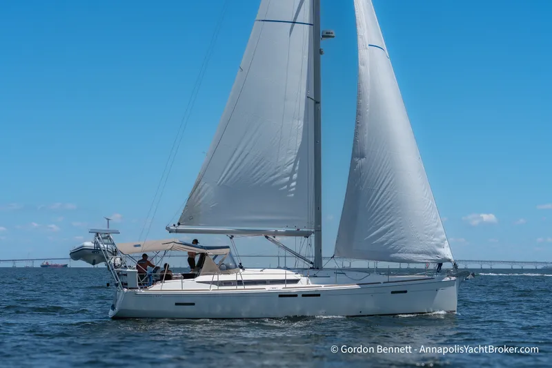 The Image of 2016 Jeanneau Sun Odyssey 439 sailing on open water under clear blue skies. - 1