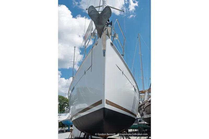 Slide: The Image of 2016 Jeanneau Sun Odyssey 439 sailboat on land, viewed from the bow under a blue sky. - 15