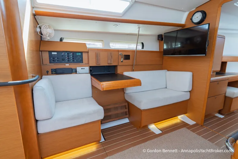 Slide: The Image of Interior of 2016 Jeanneau Sun Odyssey 439 yacht with seating, table, and electronics. - 55
