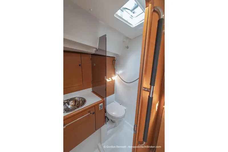 Slide: The Image of 2016 Jeanneau Sun Odyssey 439 yacht bathroom with wooden cabinetry and stainless steel sink. - 60