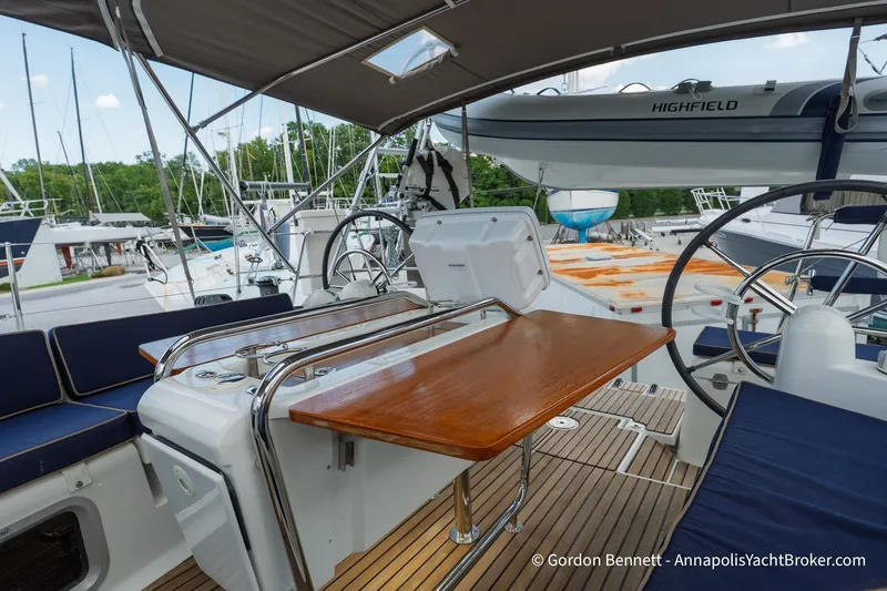 Slide: The Image of Cockpit of 2016 Jeanneau Sun Odyssey 439 yacht with wooden table and steering wheel. - 31