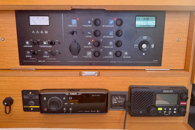 Slide: The Image of Control panel of a 2016 Jeanneau Sun Odyssey 439 sailboat, featuring navigation and communication systems. - 66