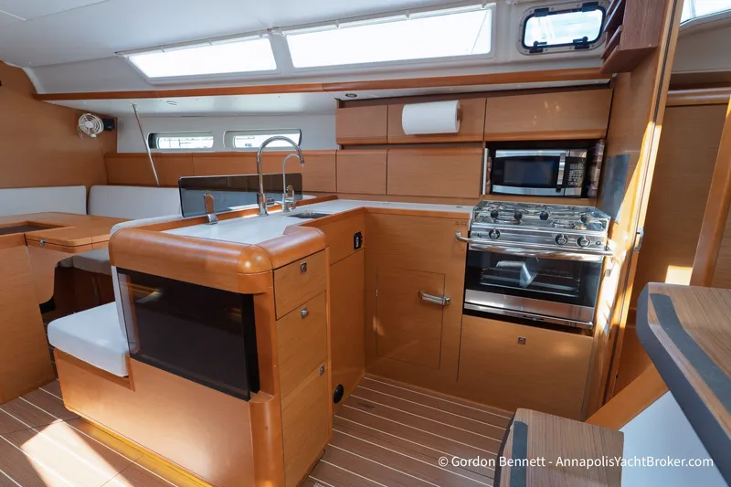 Slide: The Image of Interior of 2016 Jeanneau Sun Odyssey 439 yacht kitchen with modern appliances and wood finish. - 48