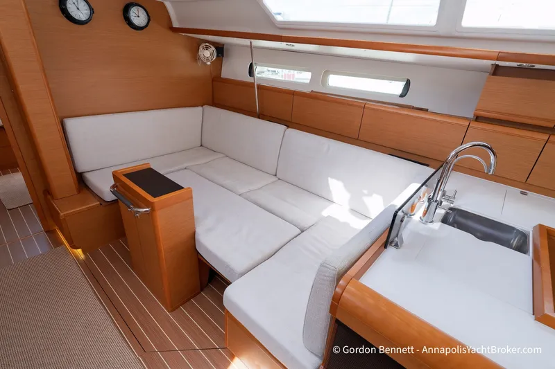 Slide: The Image of Interior of 2016 Jeanneau Sun Odyssey 439 yacht with modern seating and kitchenette. - 52