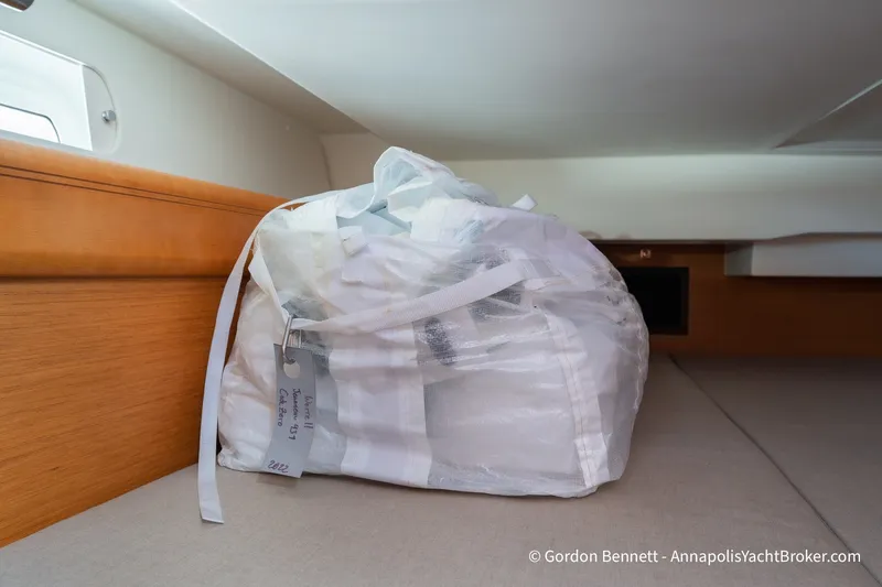 Slide: The Image of Storage area in Jeanneau Sun Odyssey 439 yacht, featuring a packed sail bag. - 65