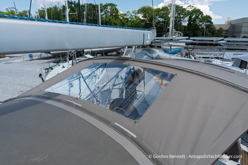 Slide: The Image of 2016 Jeanneau Sun Odyssey 439 sailboat with cockpit cover, docked in a marina. - 26