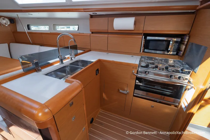 Slide: The Image of Modern kitchen in 2016 Jeanneau Sun Odyssey 439 yacht with stove, sink, and microwave. - 49
