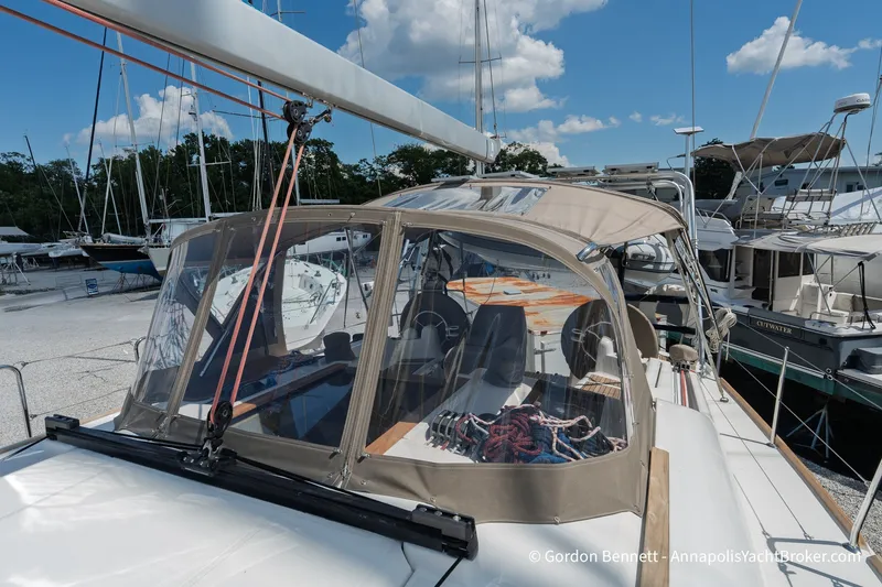 Slide: The Image of 2016 Jeanneau Sun Odyssey 439 sailboat docked, featuring a covered cockpit and clear skies. - 25