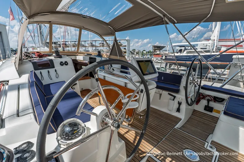 Slide: The Image of 2016 Jeanneau Sun Odyssey 439 sailboat cockpit with dual steering wheels and navigation equipment. - 28
