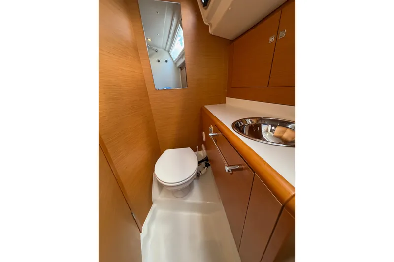 Slide: The Image of Modern bathroom in 2016 Jeanneau Sun Odyssey 439 yacht with wood finish and stainless steel sink. - 64