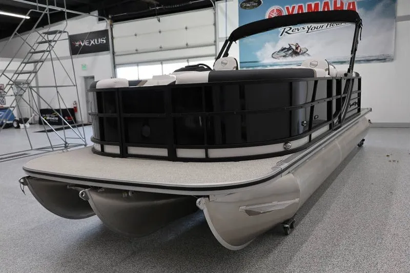 Slide: The Image of 2026 South Bay LE 224 pontoon boat in showroom, featuring sleek design and modern amenities. - 7