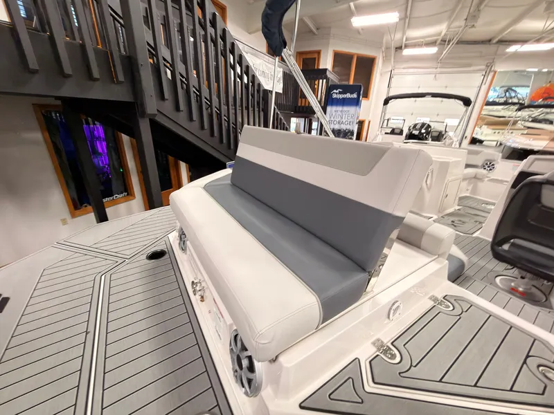 Slide: The Image of The image shows the stern of a 2027 Starcraft 211SVXIO boat with gray and white upholstery. - 9
