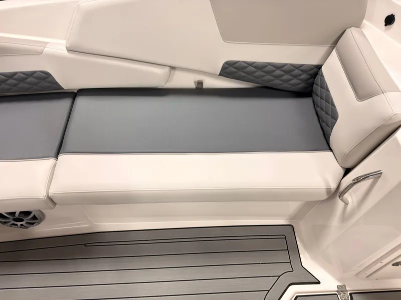 Slide: The Image of The image shows a modern boat seat with gray and white upholstery and a textured floor. - 18