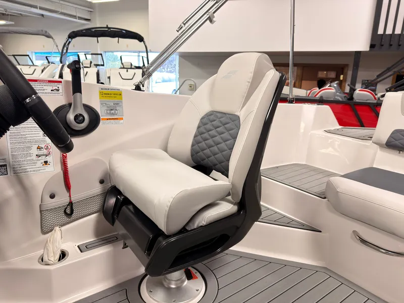Slide: The Image of Interior of a 2027 Starcraft 211SVXIO featuring a cushioned captain's chair and gray flooring. - 21