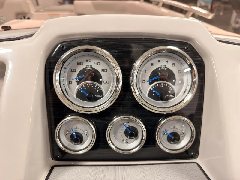 Slide: The Image of The image shows the dashboard of a Starcraft 211SVXIO boat with various gauges. - 24