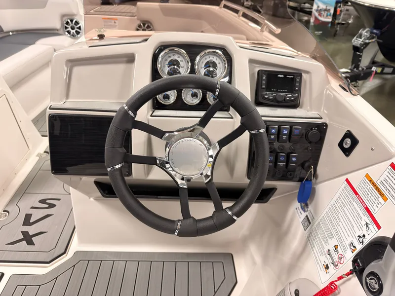 Slide: The Image of The image shows the helm of a Starcraft 211SVXIO boat with modern gauges and a steering wheel. - 23