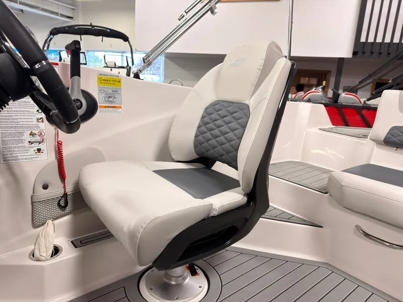 Slide: The Image of The 2027 Starcraft 211SVXIO features a modern helm with cushioned seating and gray accents. - 22