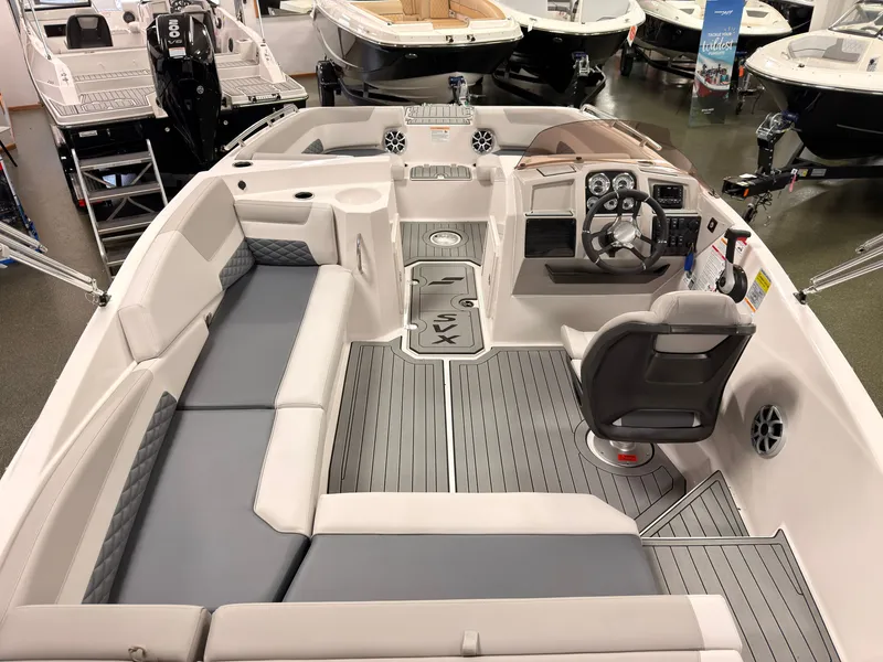 Slide: The Image of The image shows the cockpit of a 2027 Starcraft 211SVXIO. It features gray upholstery and a modern dashboard. - 12