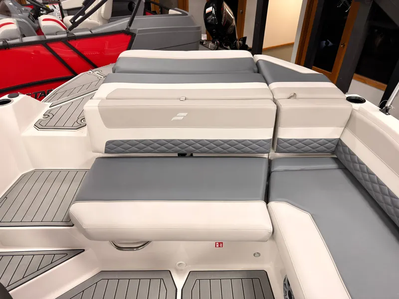Slide: The Image of The image shows the stern of a Starcraft 211SVXIO boat with gray and white upholstery. - 13