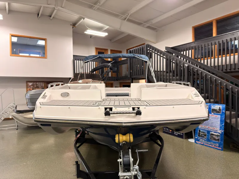 Slide: The Image of A 2027 Starcraft 211SVXIO boat is displayed in a showroom on a trailer. - 2
