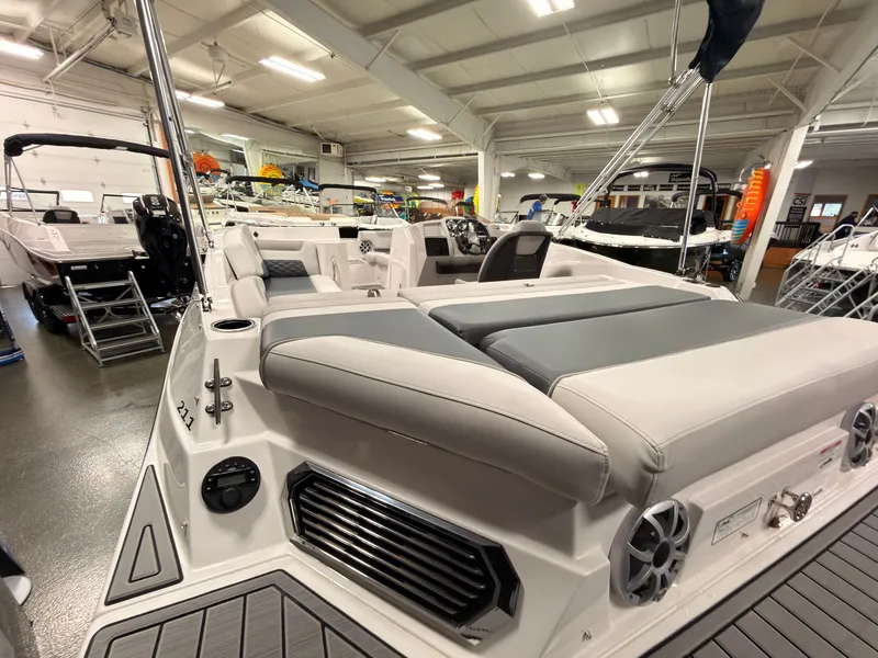 Slide: The Image of The image shows a modern Starcraft 211SVXIO boat from 2027 in a showroom. - 11