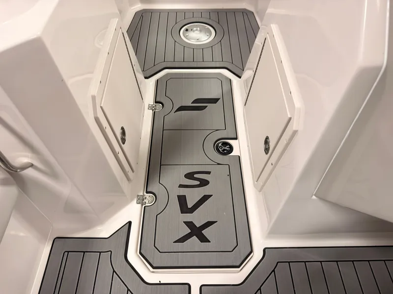 Slide: The Image of The image shows the floor of a Starcraft 211SVXIO boat with gray panels and SVX logo. - 33