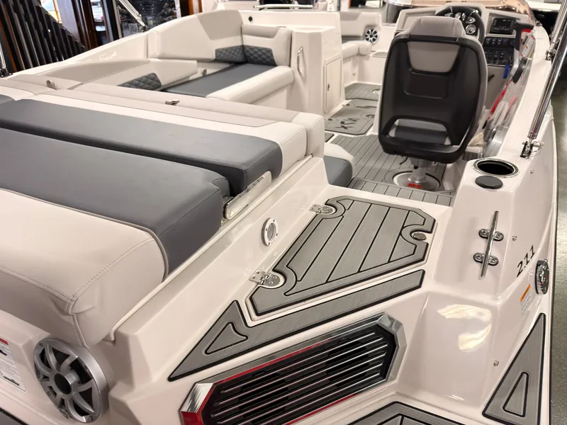 Slide: The Image of The image shows the interior of a 2027 Starcraft 211SVXIO boat with gray and white upholstery. - 6