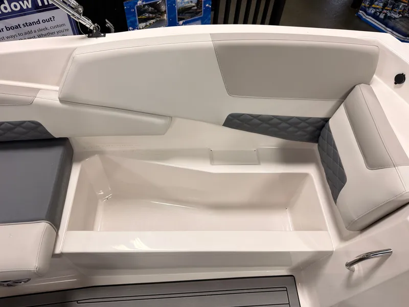 Slide: The Image of The image shows the interior of a Starcraft 211SVXIO boat with white and gray upholstery. - 19