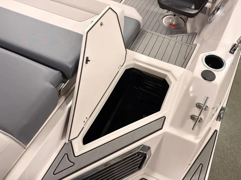 Slide: The Image of The image shows the interior of a Starcraft 211SVXIO boat with an open storage compartment. - 7