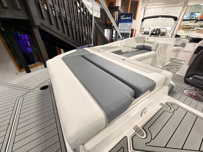 Slide: The Image of The image shows the deck of a 2027 Starcraft 211SVXIO boat with gray and white upholstery. - 8