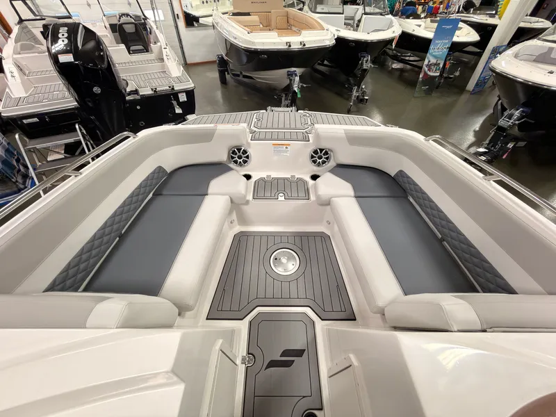 Slide: The Image of The image shows the bow area of a 2027 Starcraft 211SVXIO boat with gray upholstery. - 35