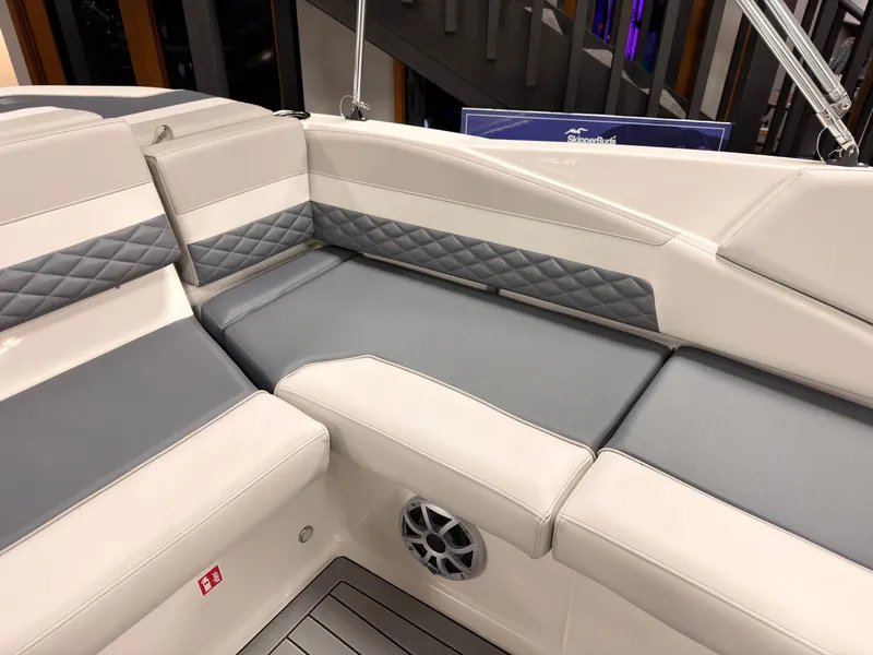 Slide: The Image of The image shows the sleek, upholstered seating area of a 2027 Starcraft 211SVXIO boat. - 16