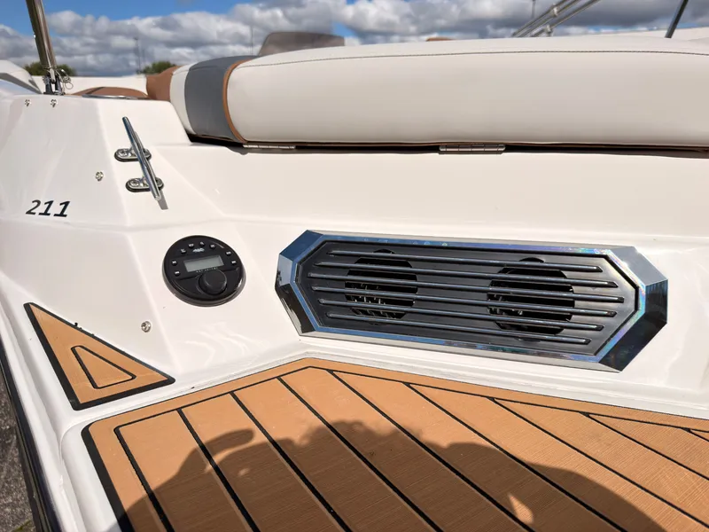 Slide: The Image of The image shows the deck of a 2027 Starcraft 211SVXIO with speakers and wood flooring. - 13