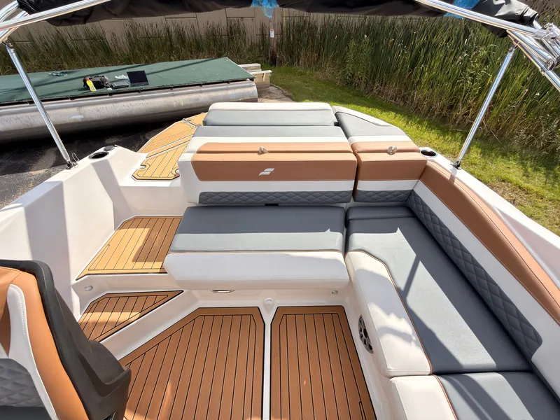 Slide: The Image of The image shows the cockpit of a Starcraft 211SVXIO boat with cushioned seating and wood flooring. - 22