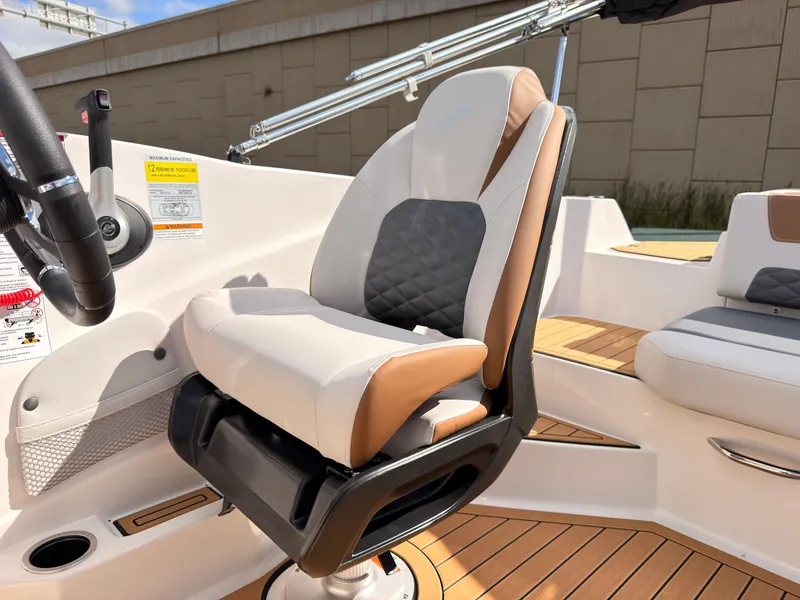 Slide: The Image of A modern boat seat with white and brown upholstery, surrounded by wood decking. - 38