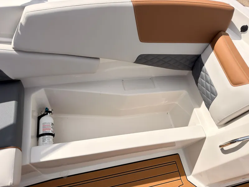 Slide: The Image of The image shows a boat seat with storage space and a fire extinguisher on board. - 34