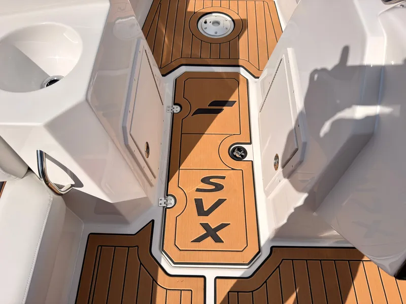 Slide: The Image of The image shows the deck of a Starcraft 211SVXIO boat with wood-like finish and SVX logo. - 46