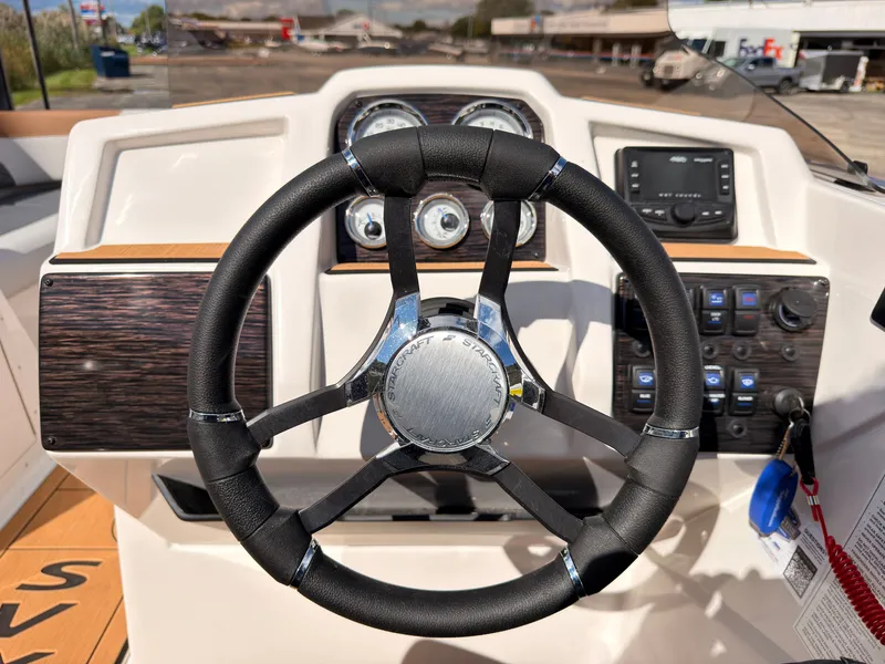 Slide: The Image of The image shows the helm of a Starcraft 211SVXIO boat with modern instruments. - 43