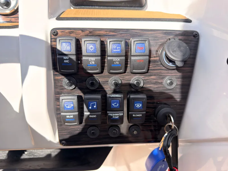 Slide: The Image of Control panel of a Starcraft 211SVXIO boat with various switches and an ignition key. - 42