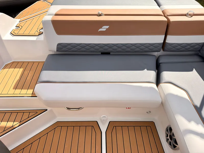 Slide: The Image of The image shows the seating area of a Starcraft 211SVXIO boat with brown and gray upholstery. - 29