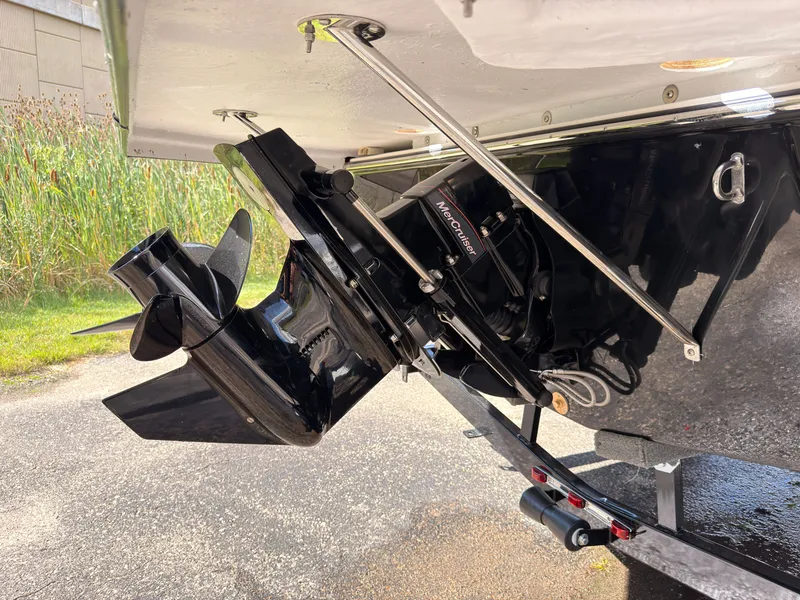 Slide: The Image of A 2027 Starcraft 211SVXIO showing its outboard motor and propeller on a trailer. - 8