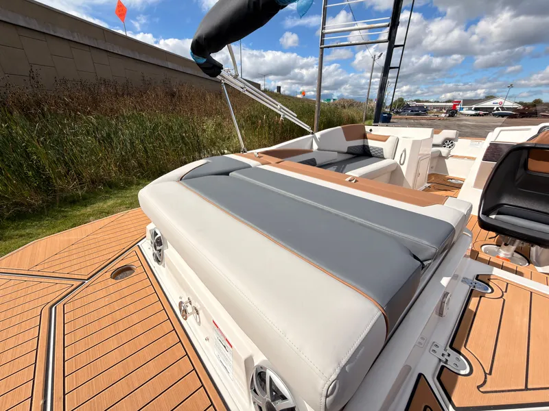 Slide: The Image of The image shows the deck of a 2027 Starcraft 211SVXIO with gray and white upholstery. - 16