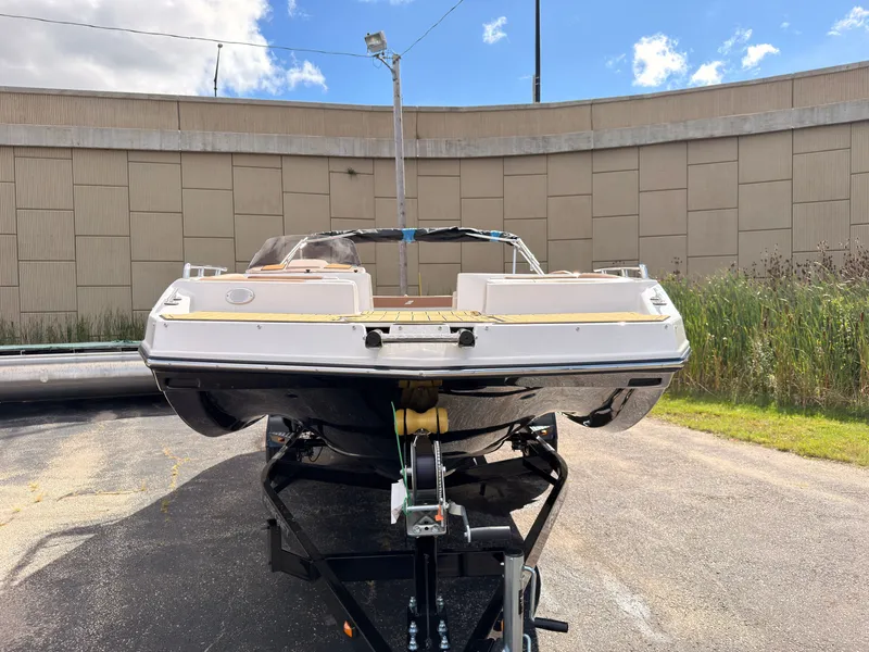 Slide: The Image of A 2027 Starcraft 211SVXIO boat is on a trailer in an outdoor area. - 2
