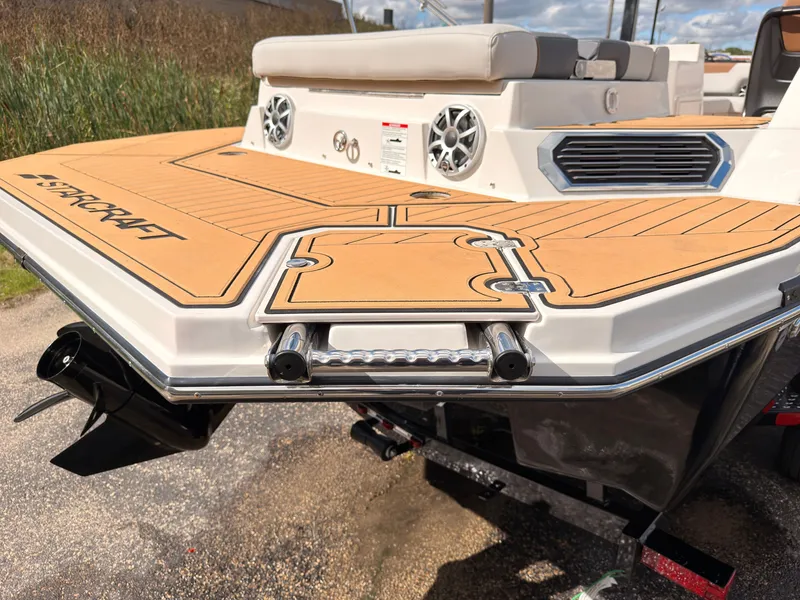 Slide: The Image of The image shows the rear of a Starcraft 211SVXIO boat with a swim platform and speakers. - 9