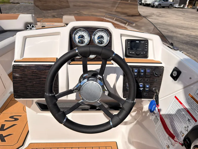 Slide: The Image of The image shows the helm of a 2027 Starcraft 211SVXIO boat with modern instruments. - 39