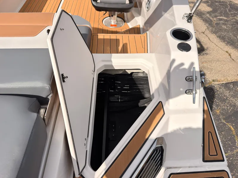 Slide: The Image of The image shows the storage compartment of a 2027 Starcraft 211SVXIO boat. - 19
